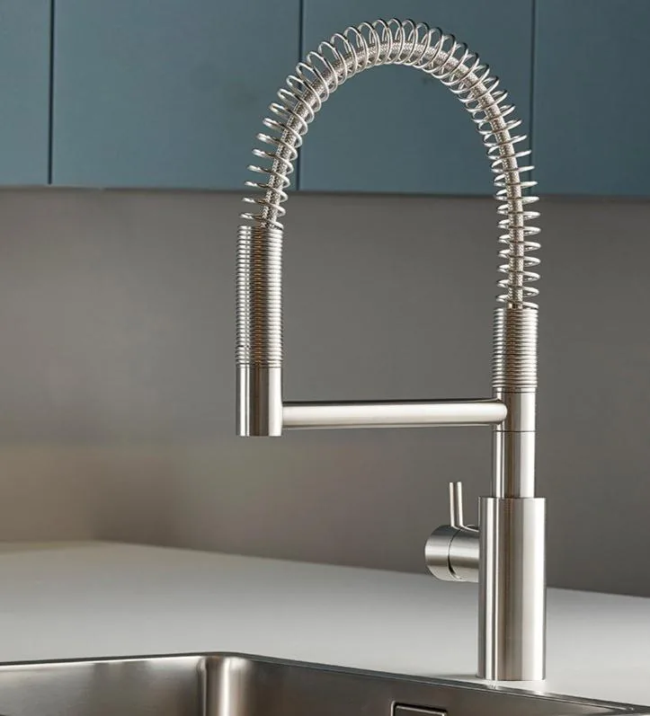 Deck mounted stainless steel kitchen sink mixer with a 360 degree swivel spout in brushed finish
