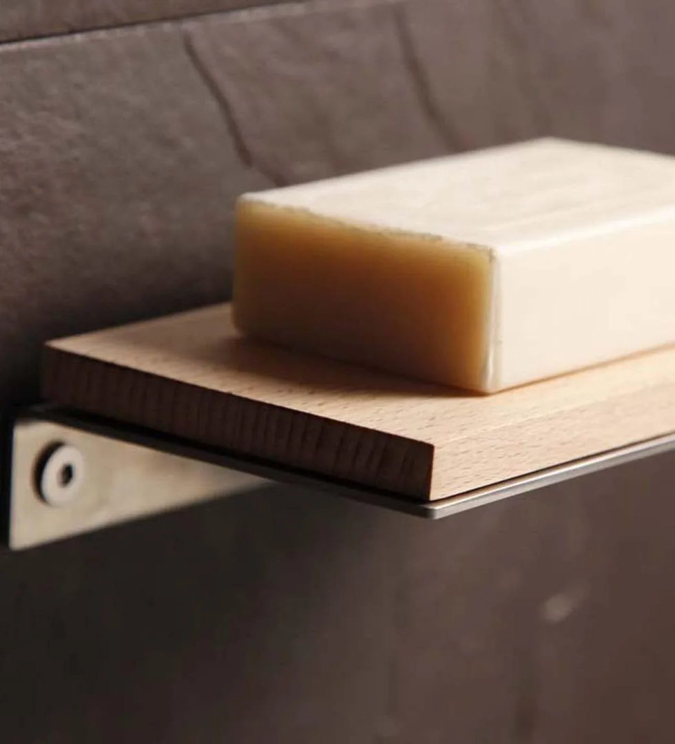 Wall-mounted stainless steel shelf for toiletries in brushed stainless steel